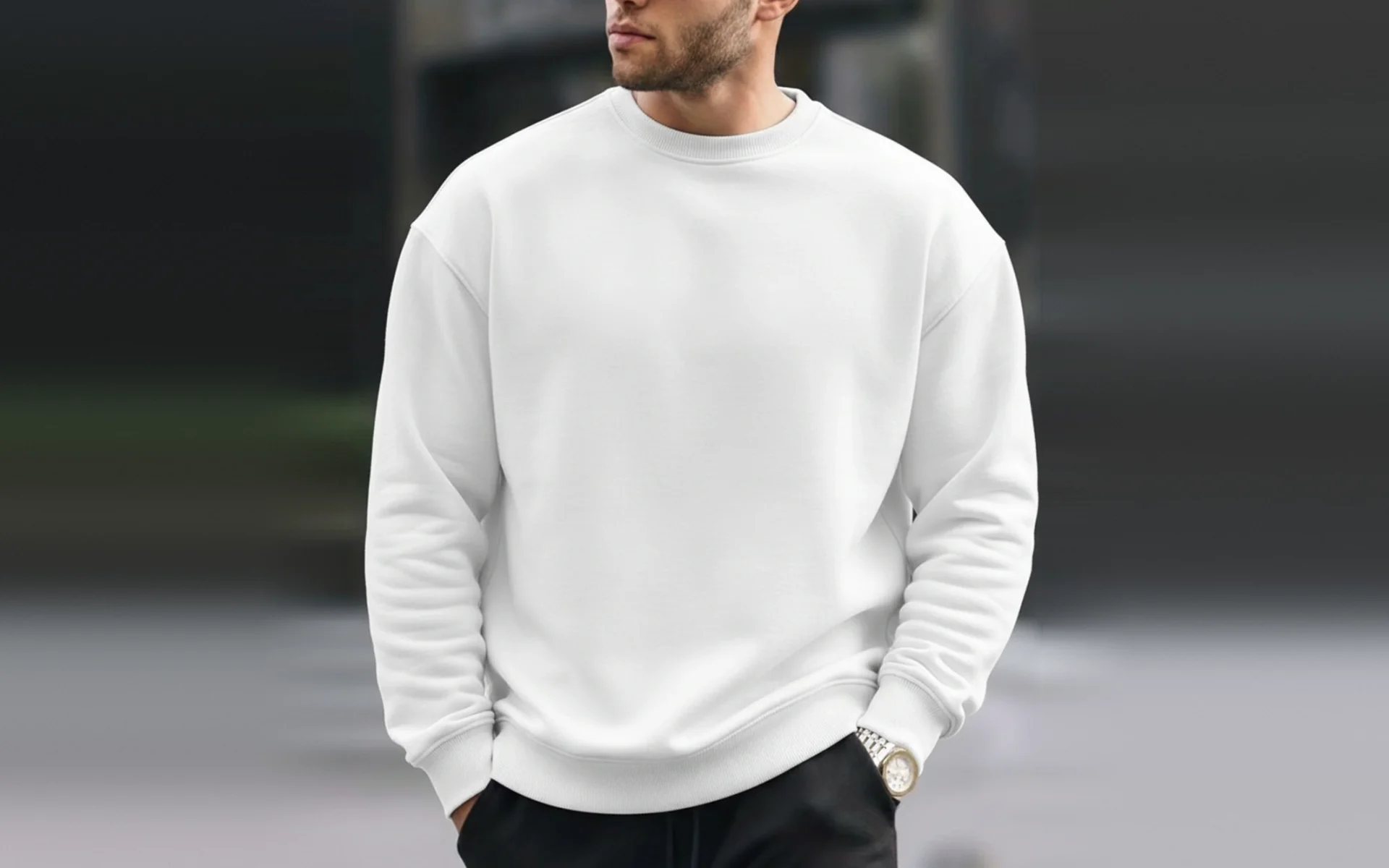 Model wearing a blank white crewneck sweatshirt, front view, with drop shoulders and ribbed collar, cuffs and hem, no print